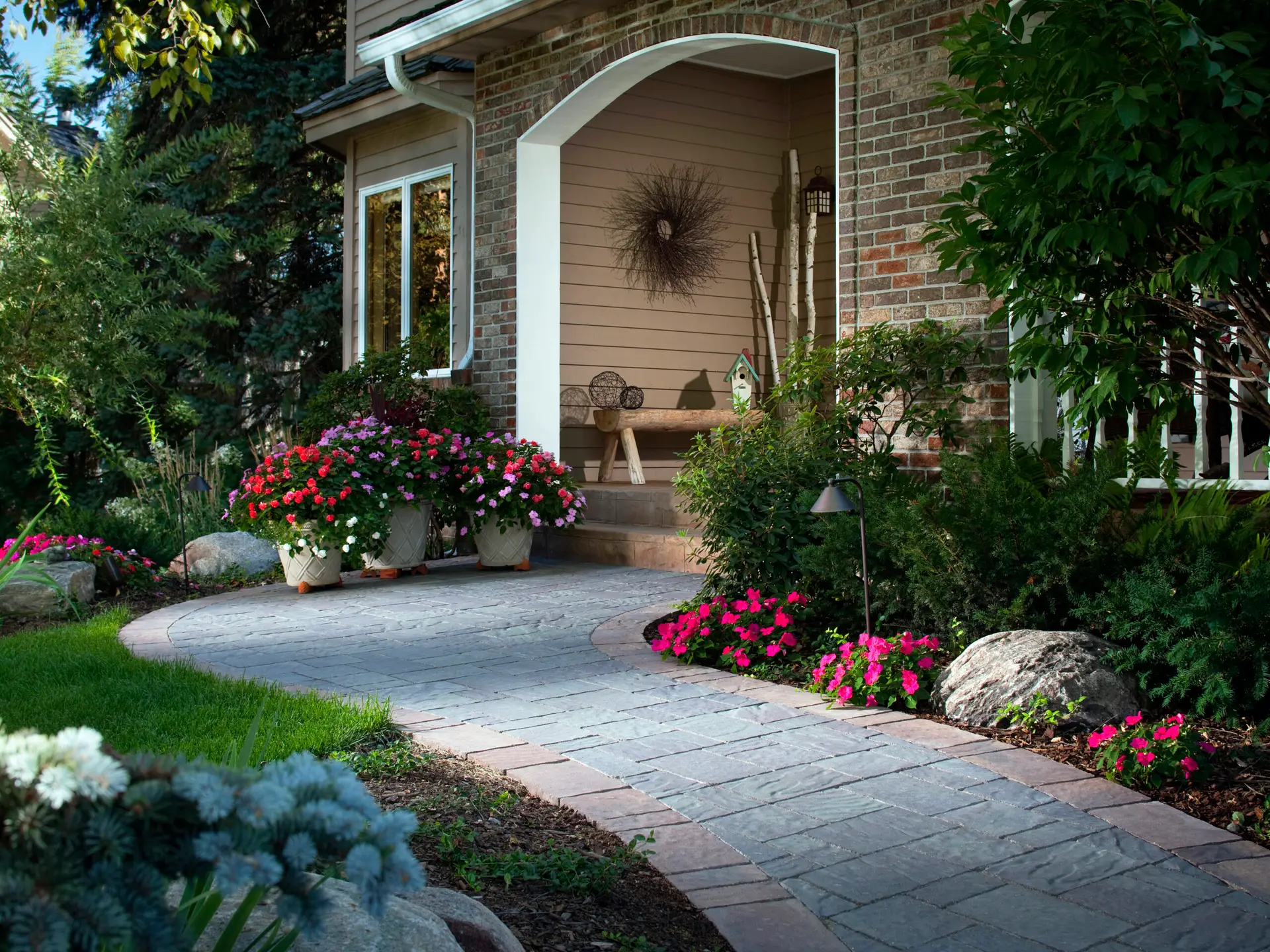 A garden path leads to a house entrance.